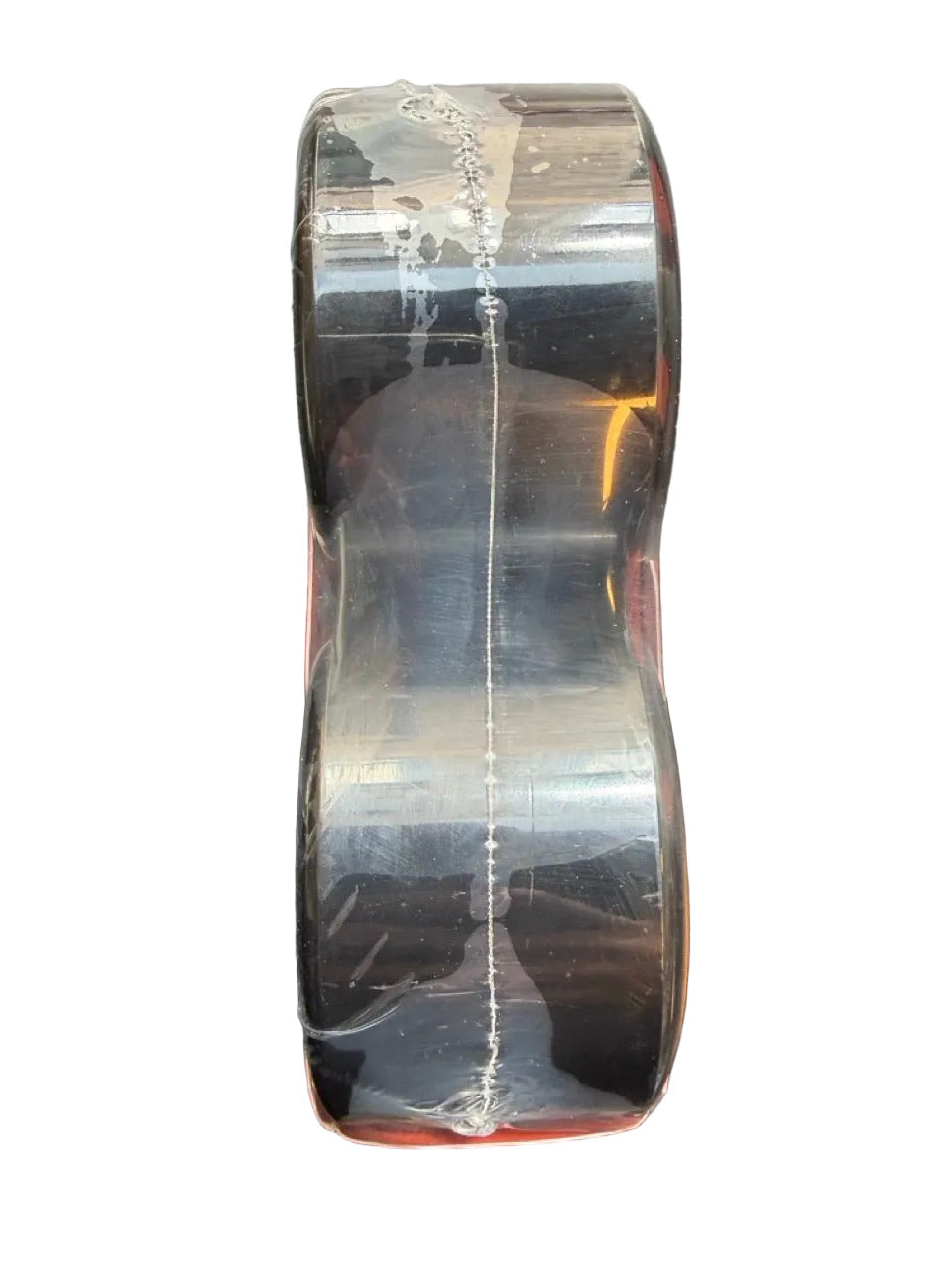 A pack of four Nothing But Free skateboard wheels in a clear plastic blister pack with a bright orange label, side view.